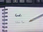 Image of notebook with written text - goal and action plan